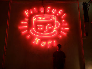 Illuminated red light painting on wall