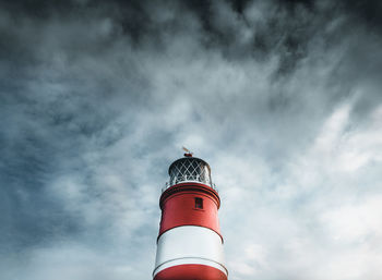 Low angle view of lighthouse against cloudy sky