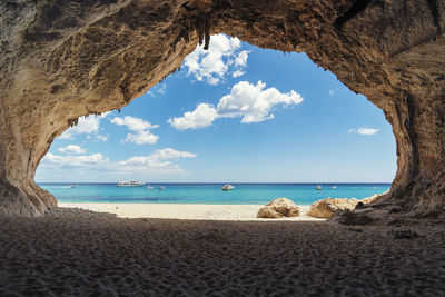 Beautiful blue sea and sky from a cave on a beach