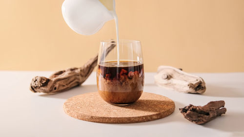 Close-up of coffee and glass on table