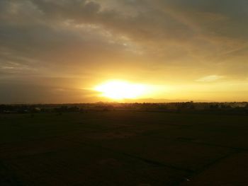 Scenic view of field against sky during sunset