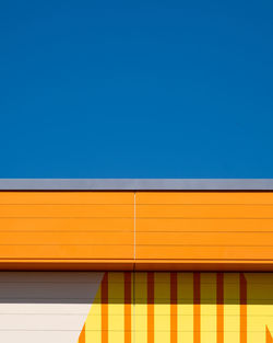 Low angle view of building against clear blue sky