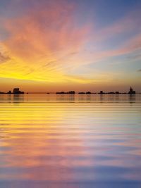 Scenic view of sea against romantic sky at sunset