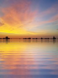 Scenic view of sea against romantic sky at sunset