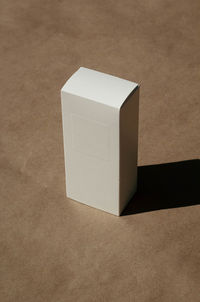 High angle view of white box on tiled floor