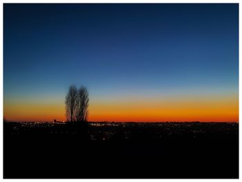 Silhouette landscape against clear sky during sunset