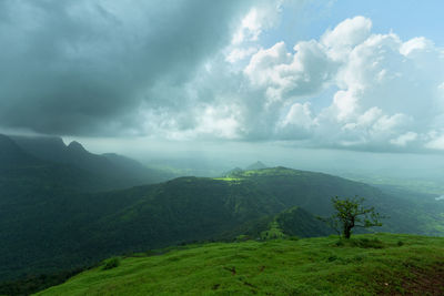 Scenic view of mountains against cloudy sky