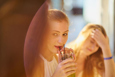 Woman with friend having drink