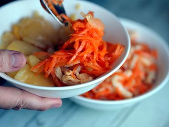 Spicy korean-style carrot salad with chicken pieces for oven-baked potatoes with vegetables. 