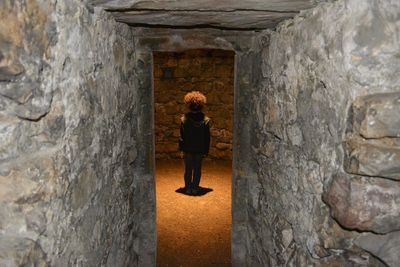 Rear view of child standing in tower