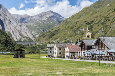 Small village in the mountains with stone houses, flowers and a river in val formazza