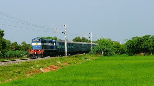 Train on railroad track against clear sky