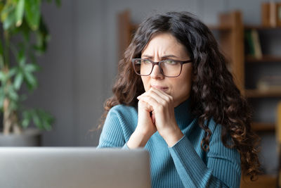 Frustrated woman at laptop think about bad news, solution for problem at work, mistake or deadline