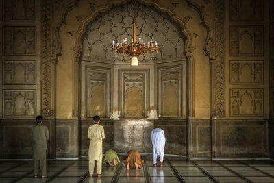 People walking in corridor of building