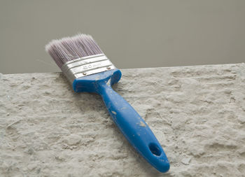 Close-up of blue paint on table