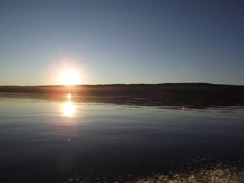 Scenic view of sea against clear sky during sunset