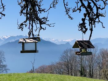 Built structure against trees and mountains against sky