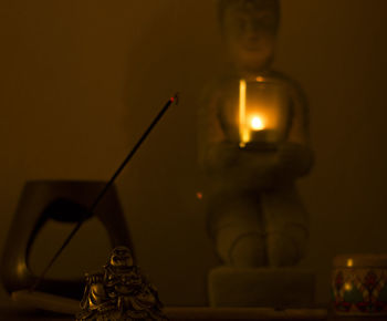 Close-up of illuminated tea light candles on table