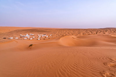 Sand dunes in desert against sky