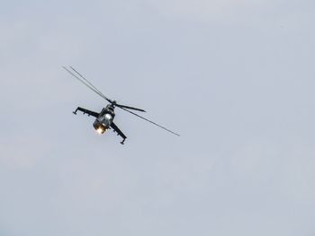 Low angle view of helicopter flying in sky