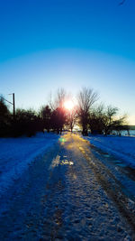 Snow covered landscape at sunset