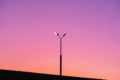 Silhouette street light against sky during sunset