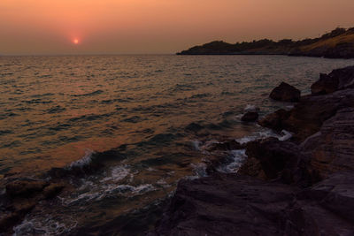 Scenic view of sea against sky at sunset