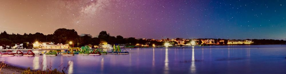 Scenic view of lake against sky at night