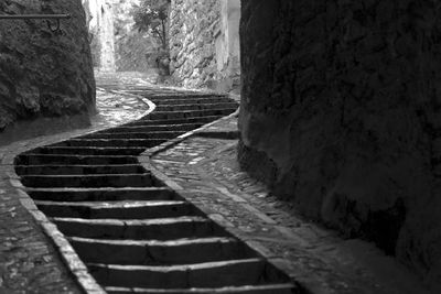 Staircase amidst old wall