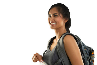 Portrait of smiling young woman against white background