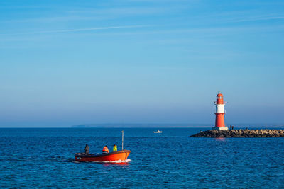 Scenic view of lighthouse on sea against sky