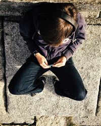 Close-up of young woman sitting on bench