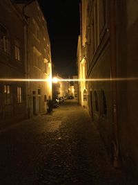 Illuminated city street at night