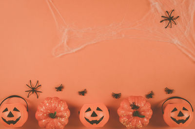 Directly above shot of jack o lantern against yellow background