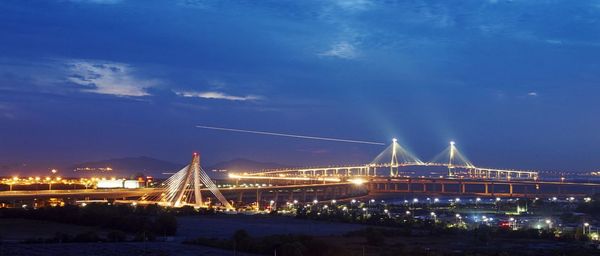 View of suspension bridge lit up at night