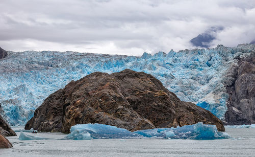 Scenic view of glacier on mountain against sky