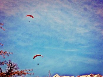 Low angle view of parachute flying in sky