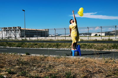 Full length of man standing on field against sky