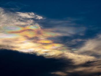 Low angle view of rainbow against cloudy sky