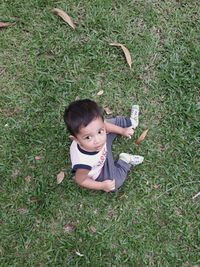 Portrait of happy boy playing on grass