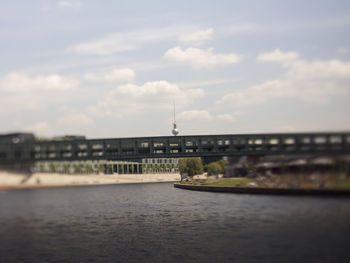 View of bridge over river against cloudy sky