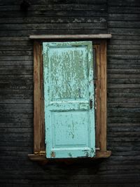 Close-up of closed window of old building