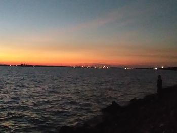 View of sea against dramatic sky during sunset