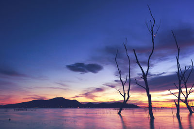 Scenic view of lake against sky at sunset