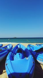 Boats in sea against clear sky