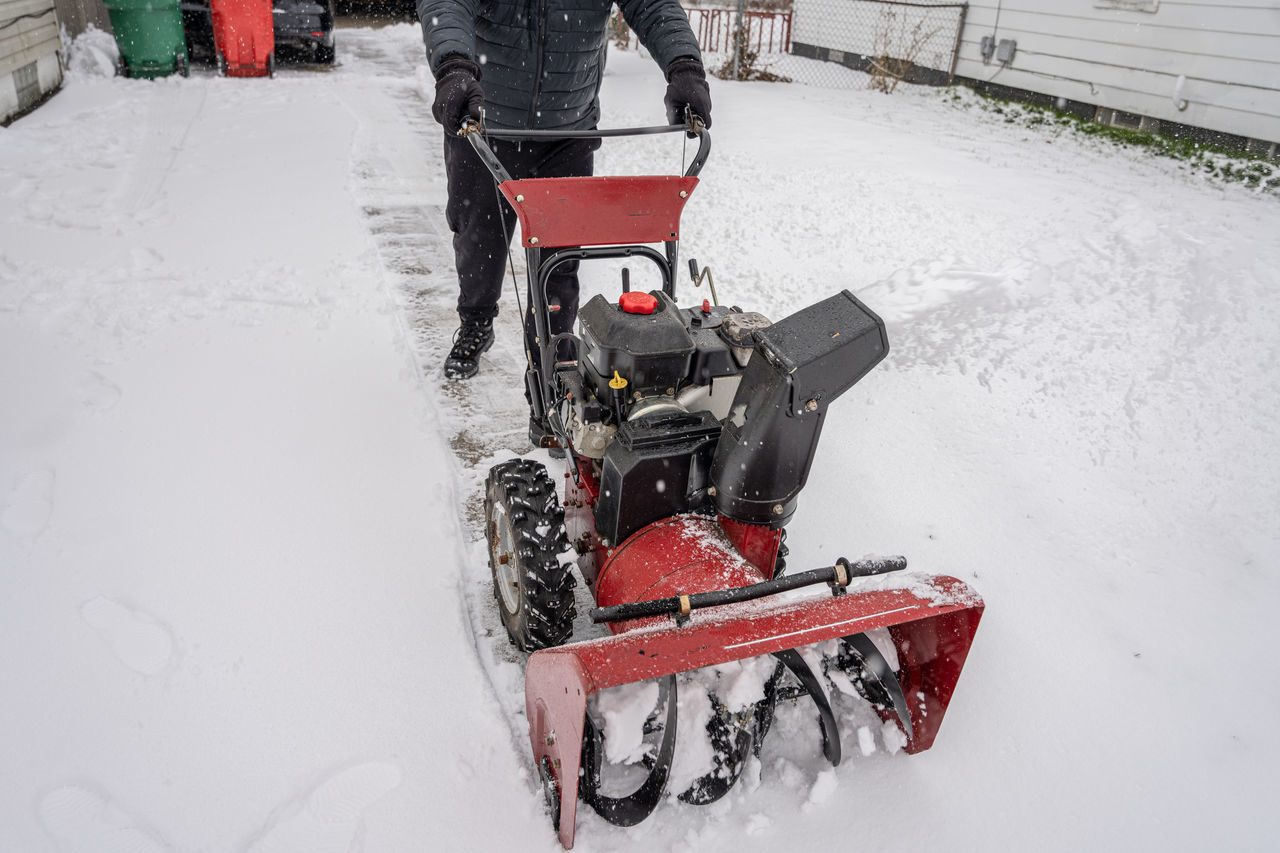 LOW SECTION OF PERSON ON SNOW COVERED LAND