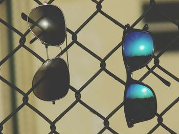 Low angle view of chainlink fence against sky