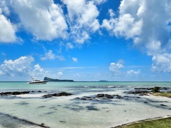 Scenic view of sea against blue sky