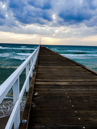 Pier over sea against sky