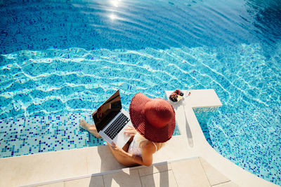 Cropped hands of woman holding swimming pool